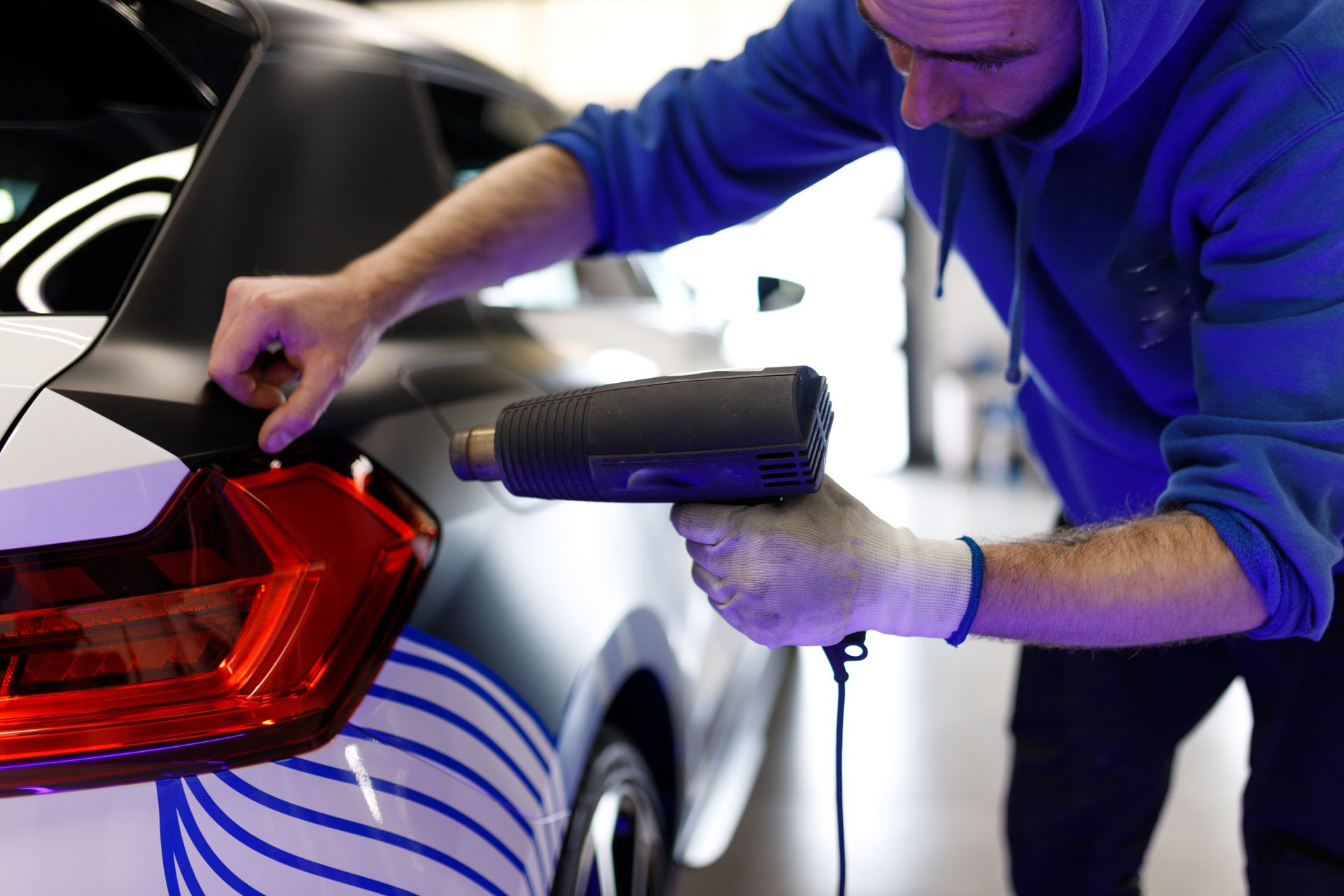 A gray house with a blue door and windows