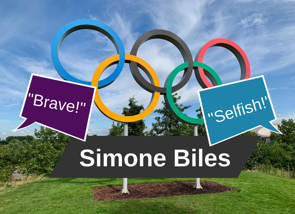 A statue of the Olympic rings with speech bubbles that say 
