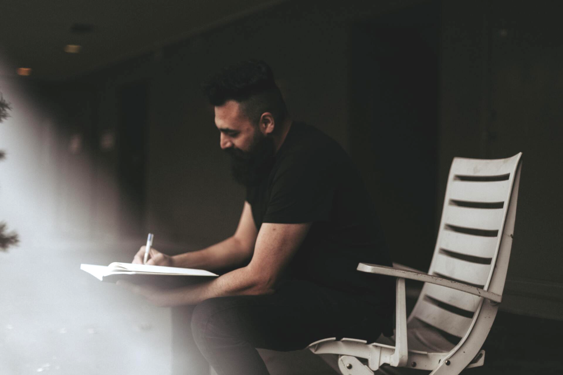 Man writing in a counseling journal