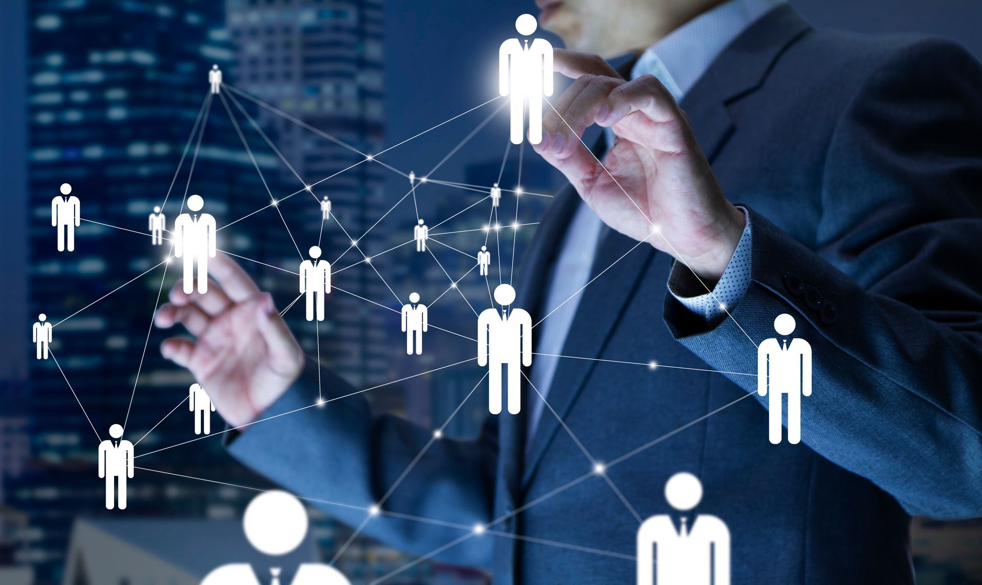 Man in suit touching digital network of people icons, city backdrop.