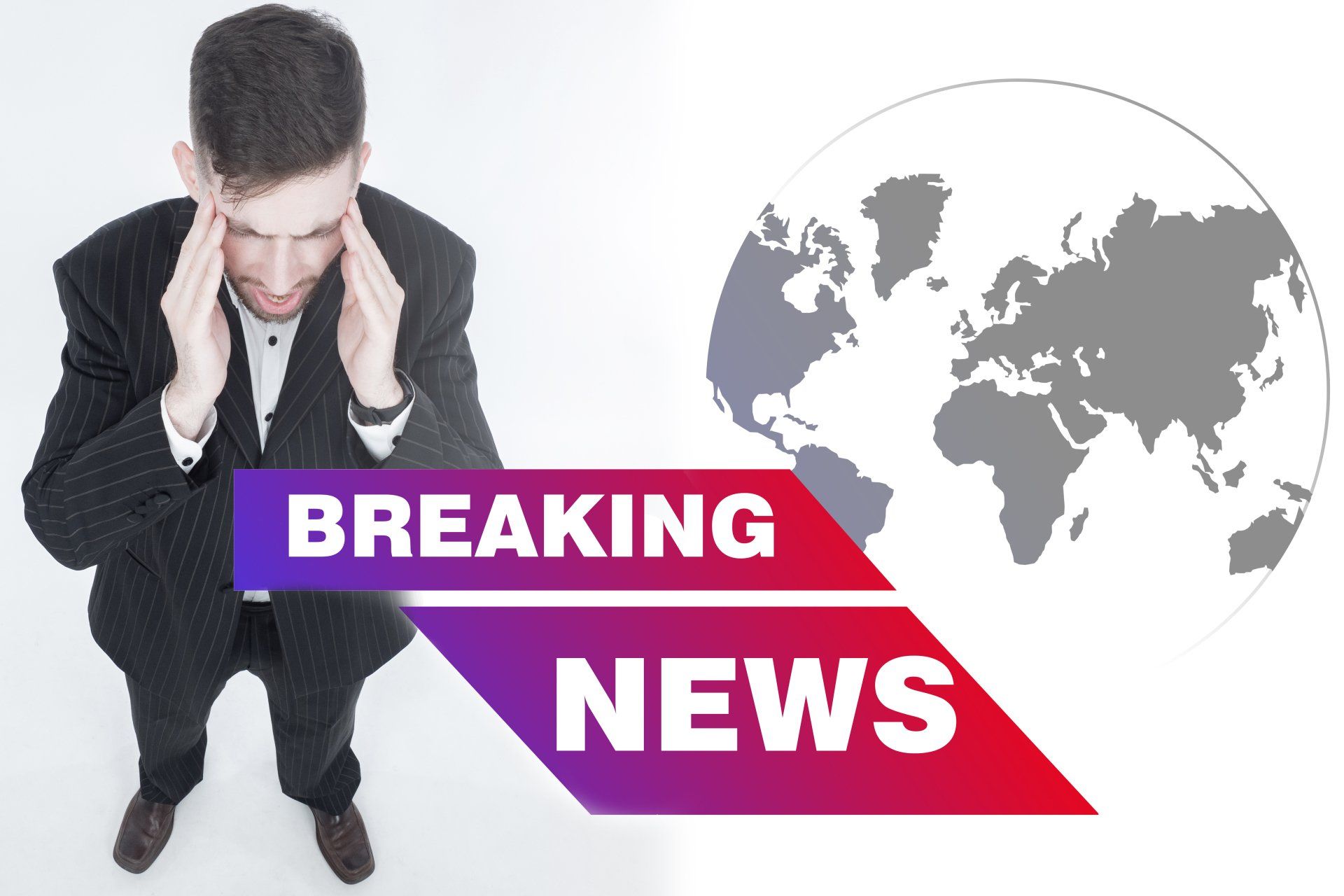 A man is sitting in front of a breaking news sign