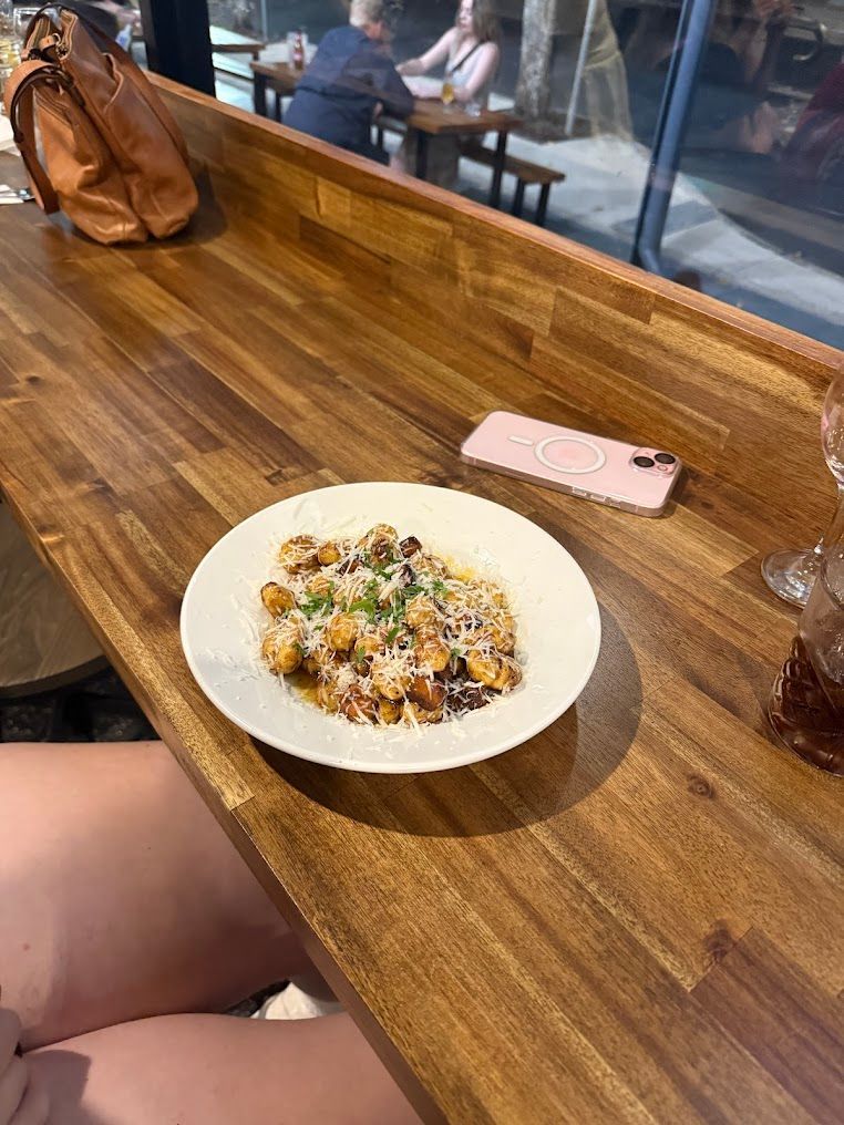 A Plate Of Food Is Sitting On A Wooden Table — Mumbo's Pizza'n'Pasta In Lismore, NSW