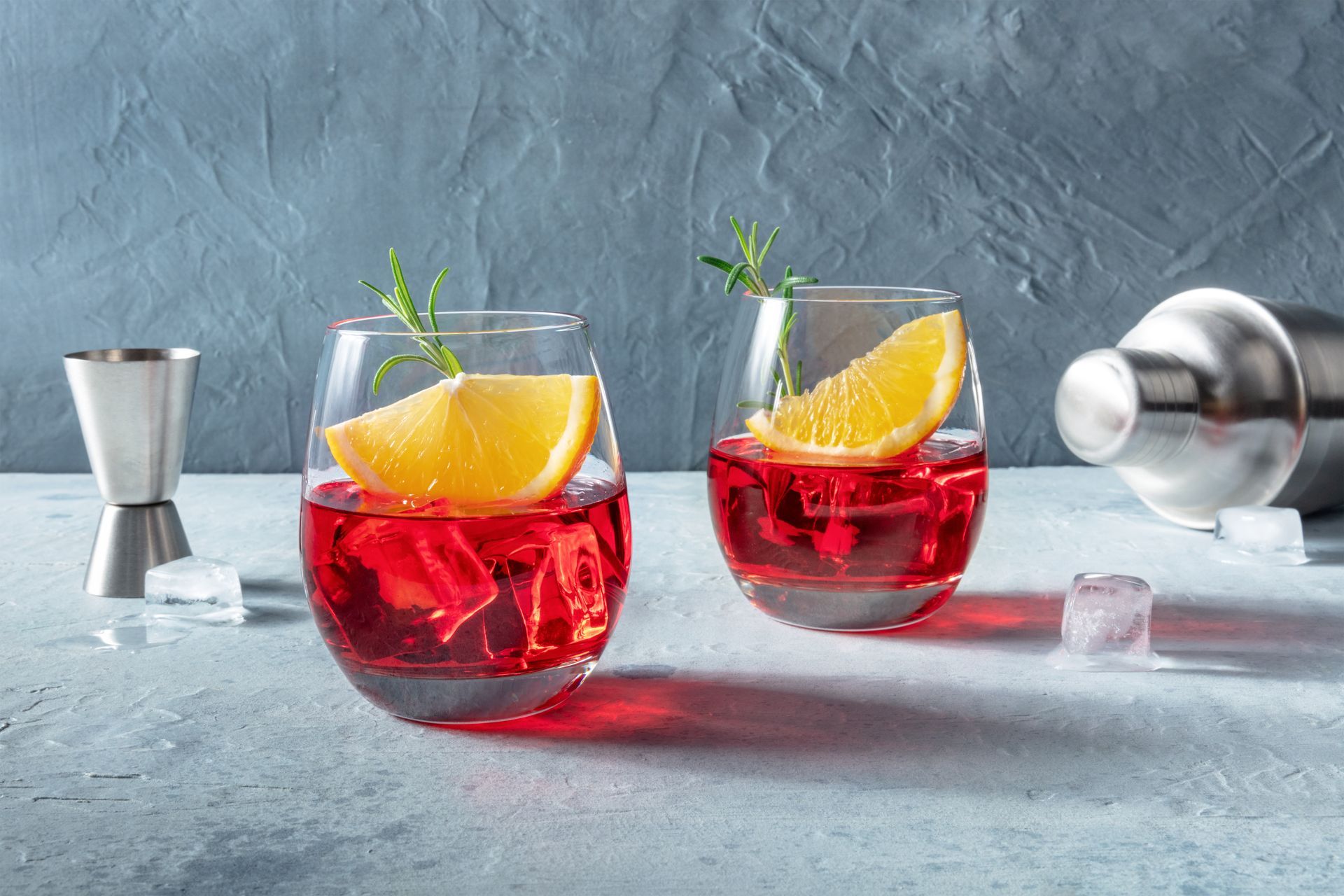 Two Glasses of Red Liquid With Ice and Orange Slices on a Table — Mumbo's Pizza'n'Pasta In Lismore, NSW