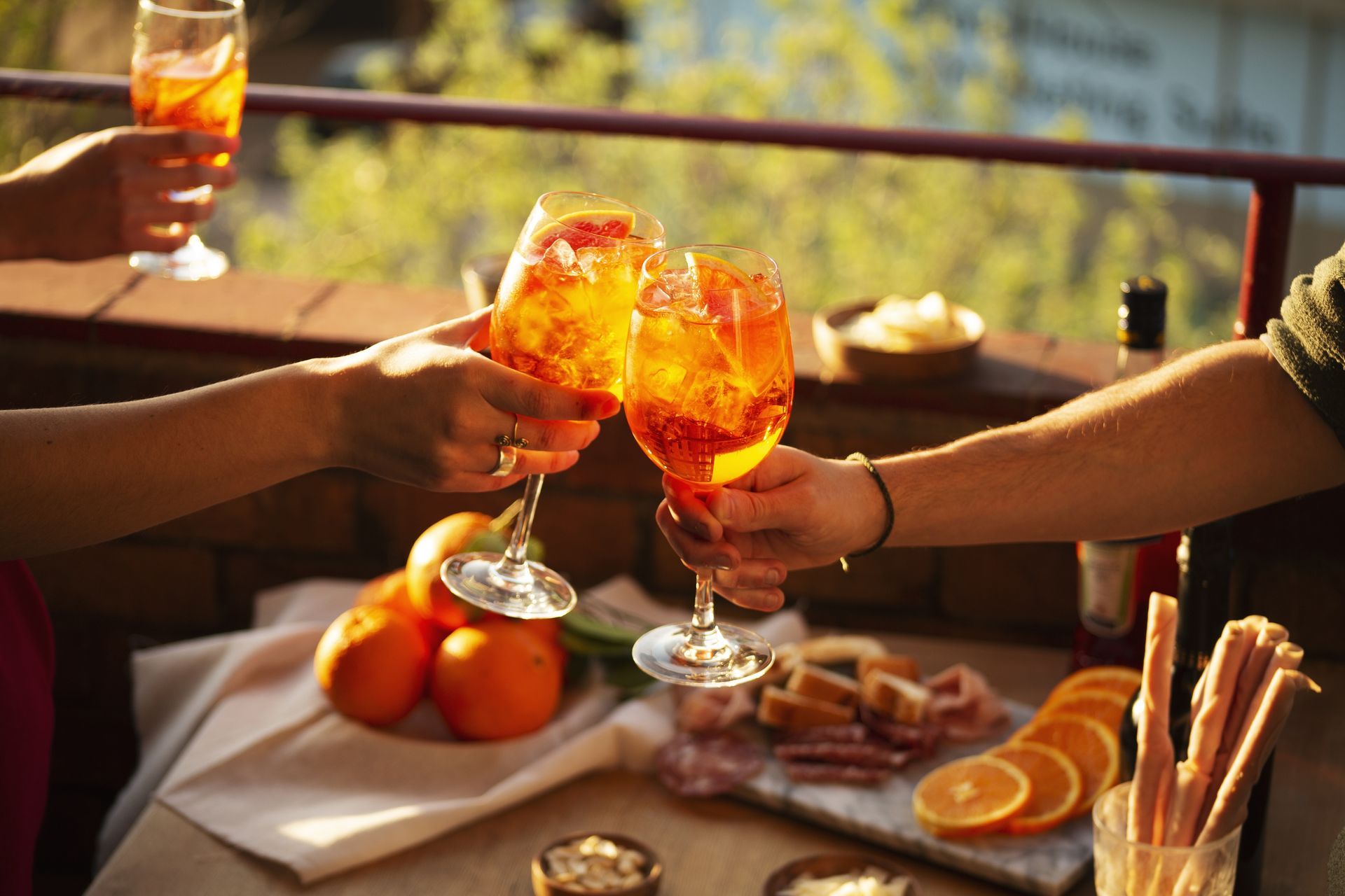 Two People Are Toasting With Drinks at a Table — Mumbo's Pizza'n'Pasta In Lismore, NSW