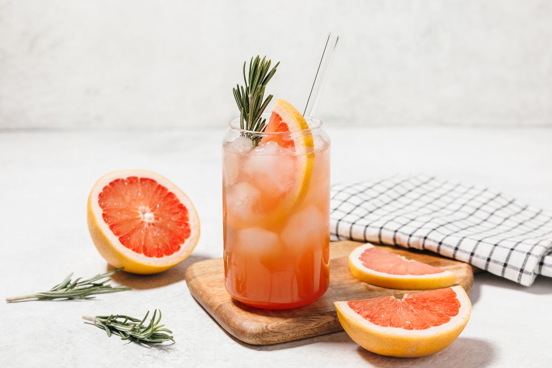 A Glass of Grapefruit Juice With Ice and a Straw on a Cutting Board — Mumbo's Pizza'n'Pasta In Lismore, NSW