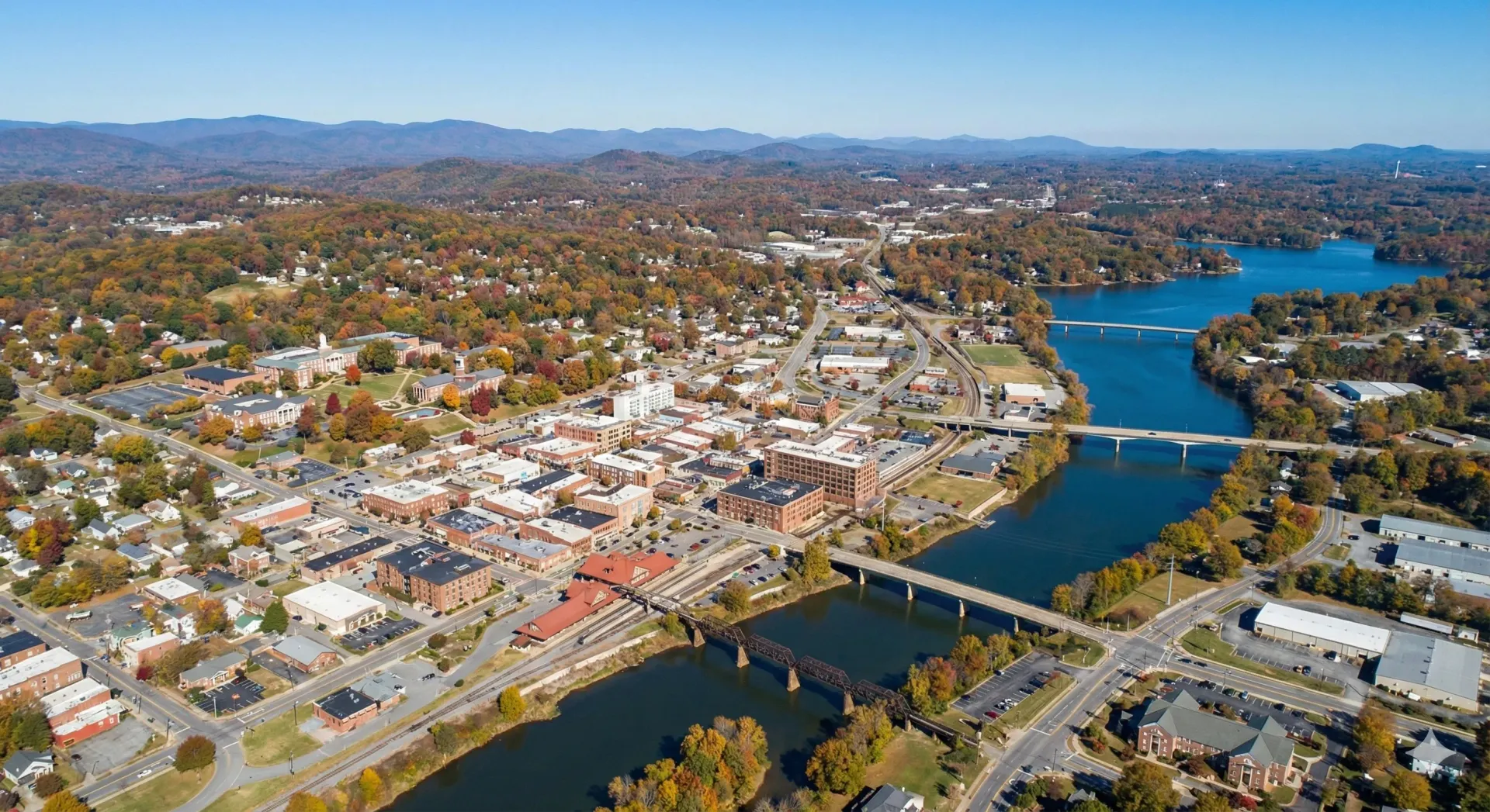 An aerial view of a city with a lake in the background.