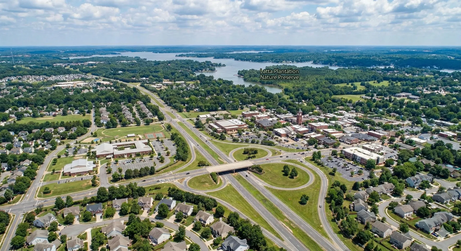 An aerial view of a city with a lake in the background.