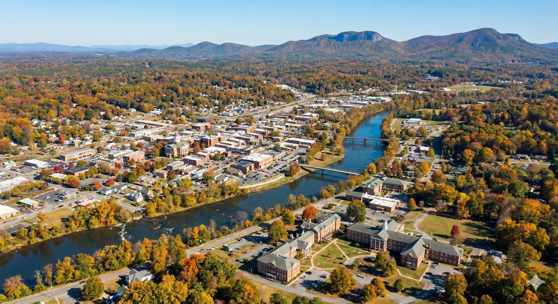 An aerial view of a city with a lake in the background.