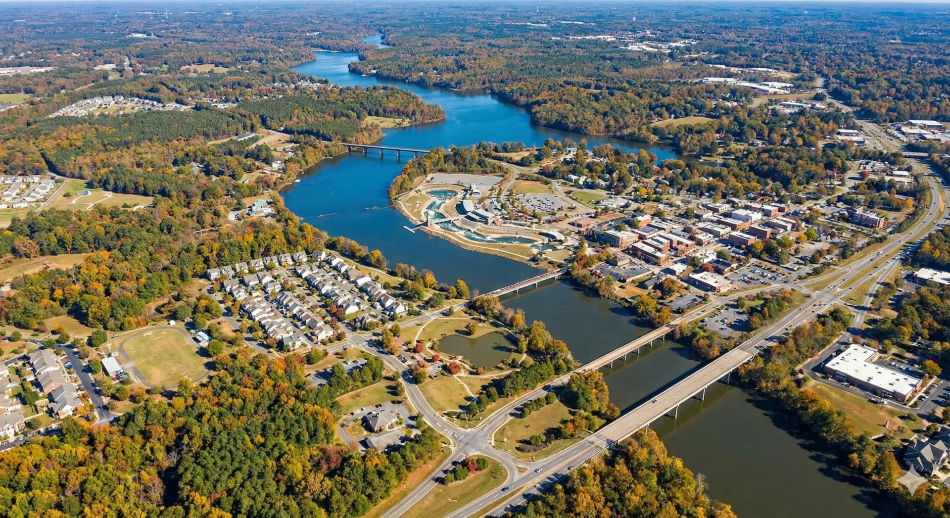 An aerial view of a city with a lake in the background.