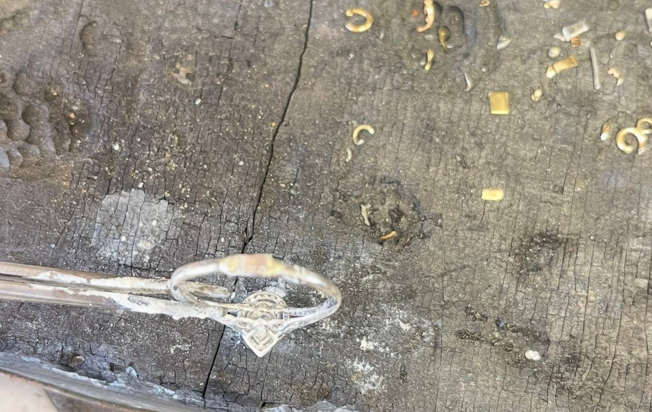 Worn concrete floor with a looped white cable or rope near a crack and small yellow markings