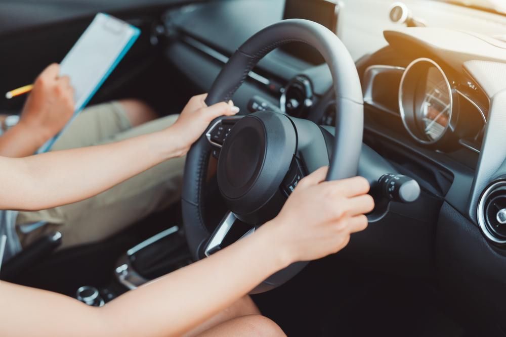 A Woman Is Taking A Driving Test In A Car — Primera Driving School Darwin In Stuart Park, NT