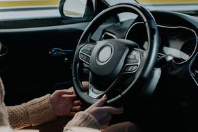 Female Hands Holding Steering Wheel in a Car — Central Islip, NY — Defensive Driving School Female Hands Holding Steering Wheel in a Car — Central Islip, NY — Defensive Driving School