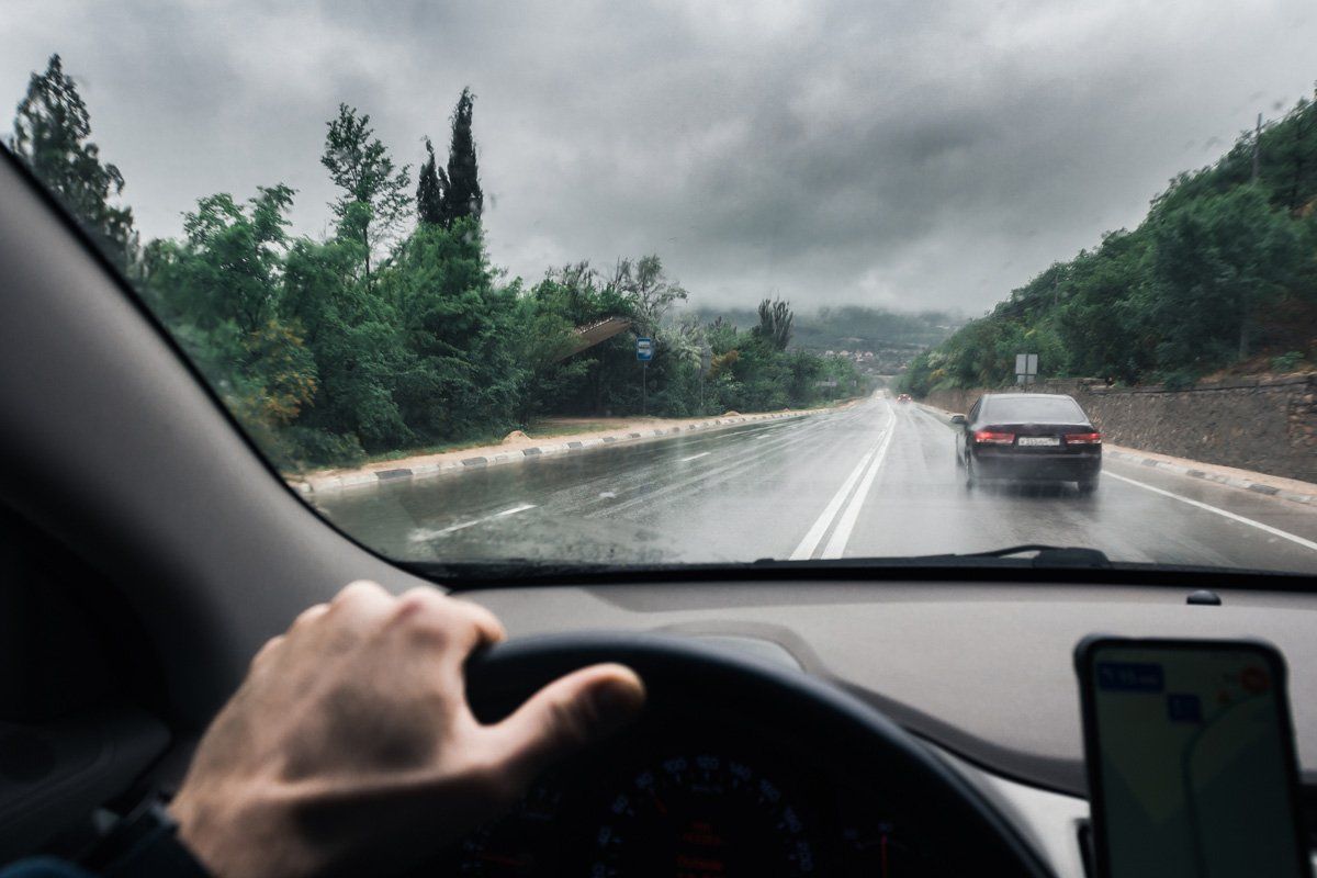 View Through the Windshield on a Wet Highway in the Rain — Central Islip, NY — Defensive Driving School View Through the Windshield on a Wet Highway in the Rain — Central Islip, NY — Defensive Driving School