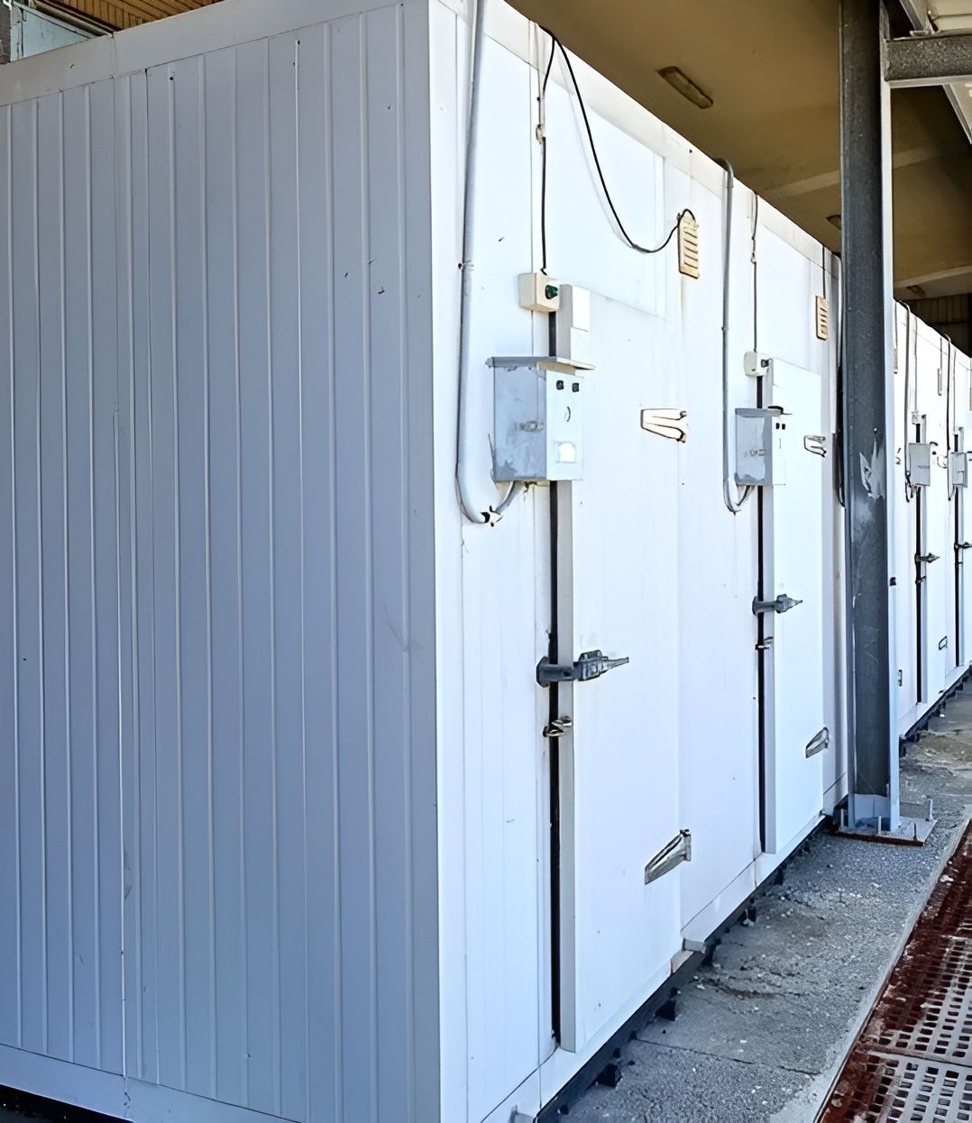 A Row Of White Containers Are Lined Up Next To Each Other — South Coast Refrigeration & Air Conditioning In Bomaderry, NSW