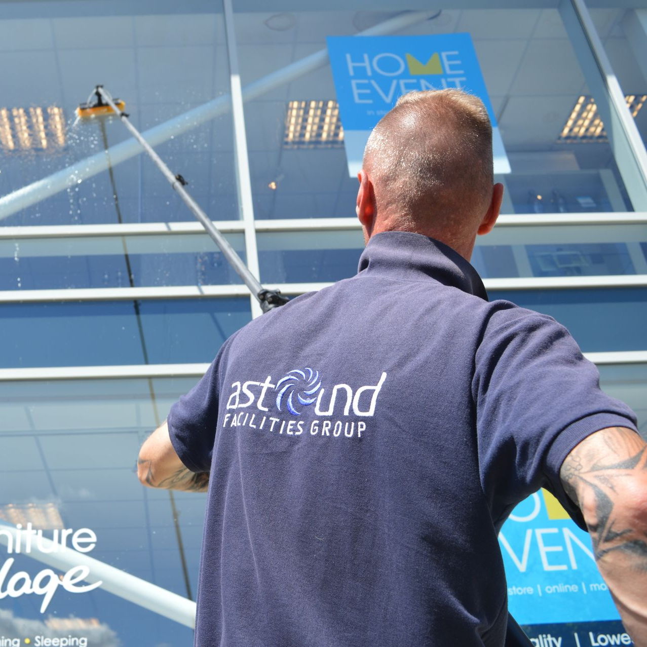 Commercial window cleaning using telescopic pure water fed pole on shopfront glass