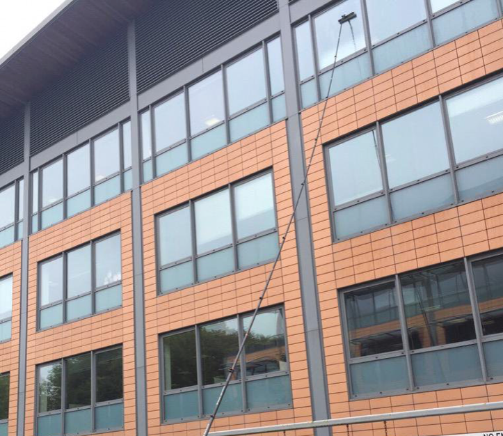 Telescopic water fed pole cleaning a high level complex building