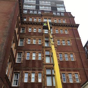 High-rise window cleaner in Worthing working from suspended cradle