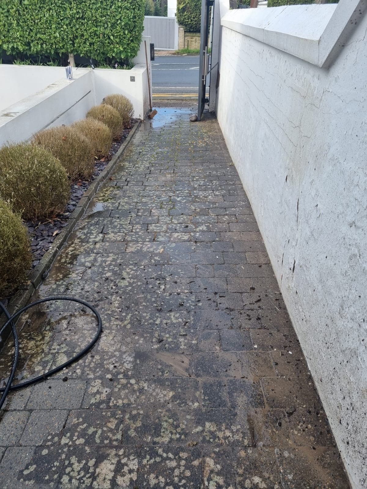 Before — residential pressure washing of block paving driveway at a Sussex home by Astound Cleaning Group