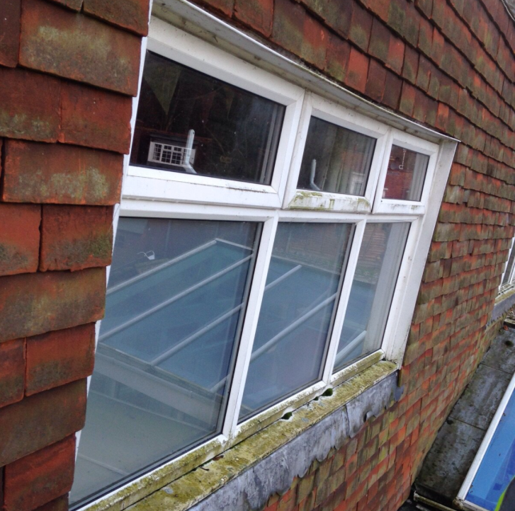 Dirty residential window before window cleaners near me in littlehampton cleaned it