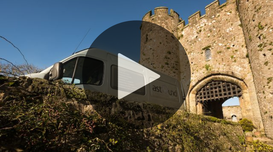 Astound Van leaving castle gate after providing heritage external cleaning on a Blue sky, sunny day.