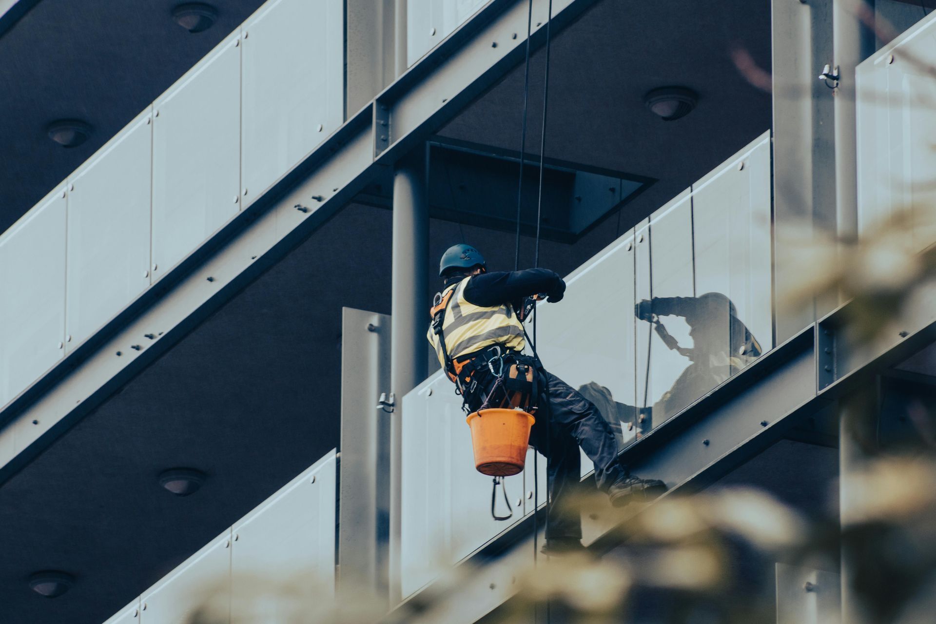 Man abseiling a commercial building for window cleaning