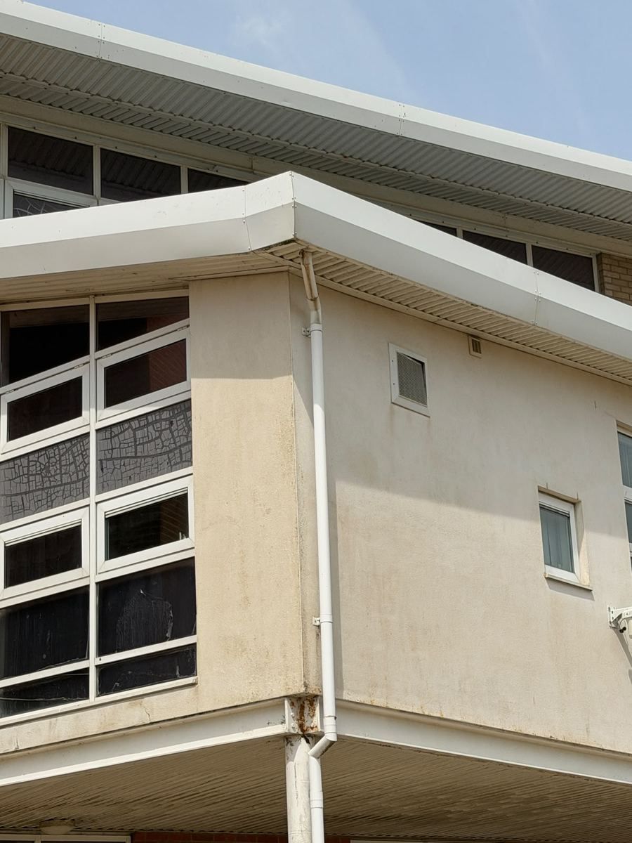 The same rendered elevation after professional soft wash render cleaning, algae and staining removed