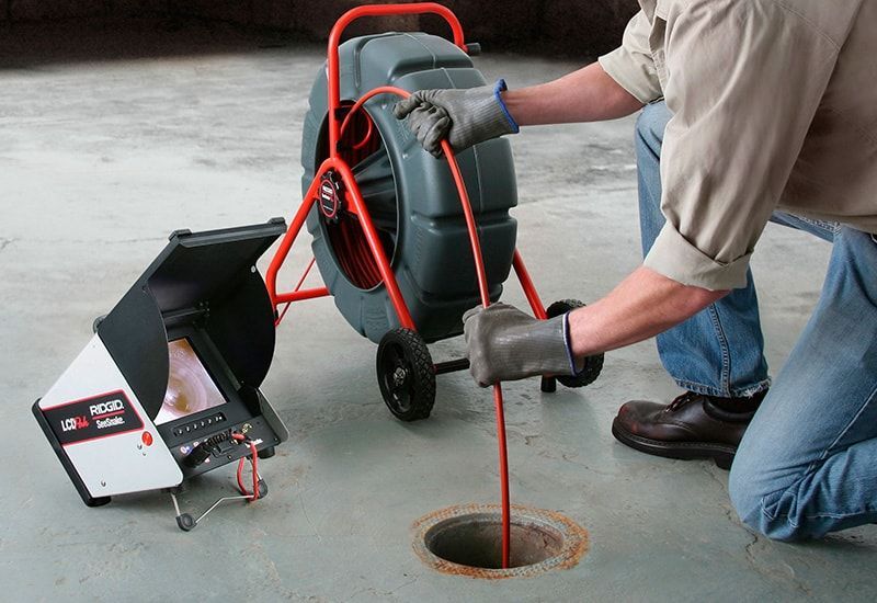 drain being cleaned