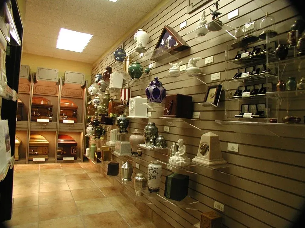 Store aisle with slatwall shelves displaying assorted home decor and gift items under bright lighting
