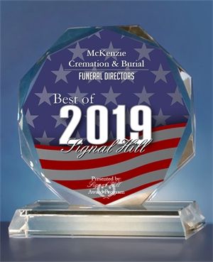 Faceted crystal award reading “Best of 2019” with stars and U.S. flag design on a clear base