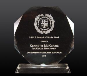 Black glass award plaque reading “CSULB School of Social Work Honors” for Kenneth McKenzie, Outstanding Community Educator 2018