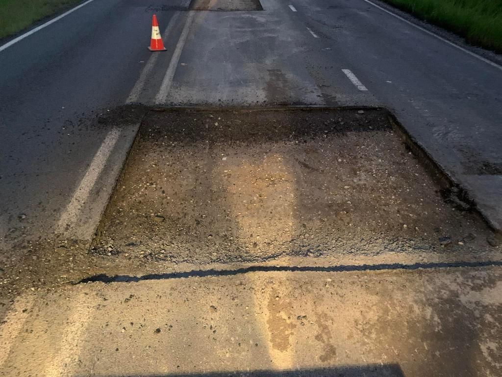 Large Hole in the Middle of a Road Next to a Traffic Cone — JP Civilworx Pty Ltd in Gosford, NSW