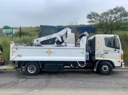White Truck With a Crane on the Back is Parked on the Side of the Road — JP Civilworx Pty Ltd in Cessnock, NSW
