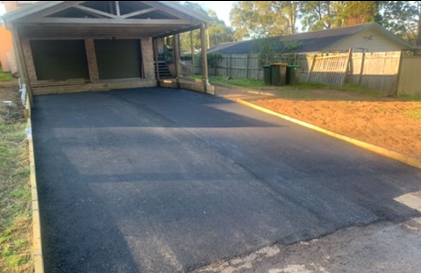 A Drive Way Next To A Garden And Bins — JP Civilworx Pty Ltd in Eraring, NSW