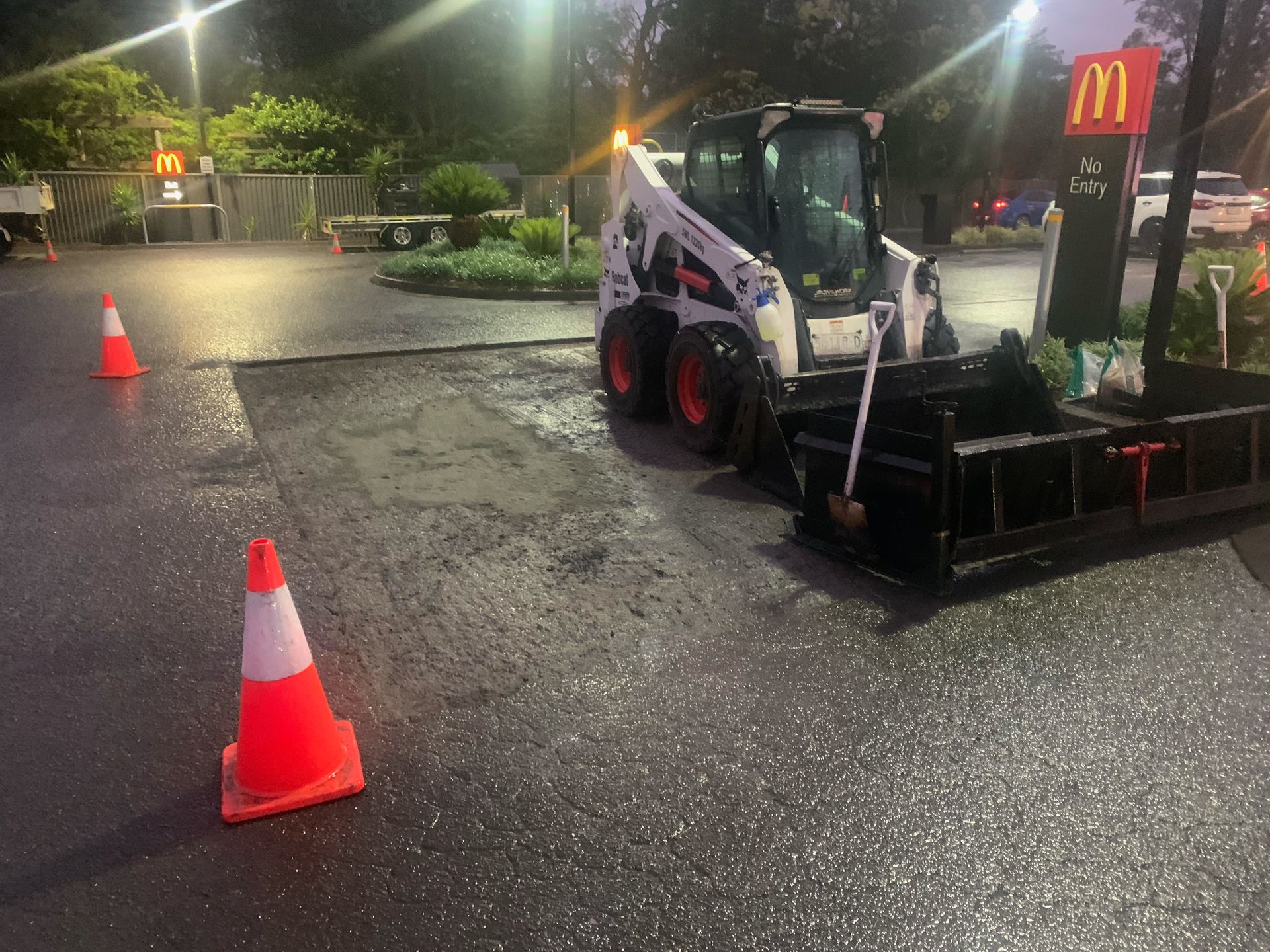 A Construction Vehicle In A Carpark Next To A Cone — JP Civilworx Pty Ltd in Eraring, NSW
