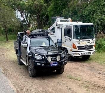 Two Trucks Are Parked Next to Each Other on the Side of the Road — JP Civilworx Pty Ltd in Taree, NSW