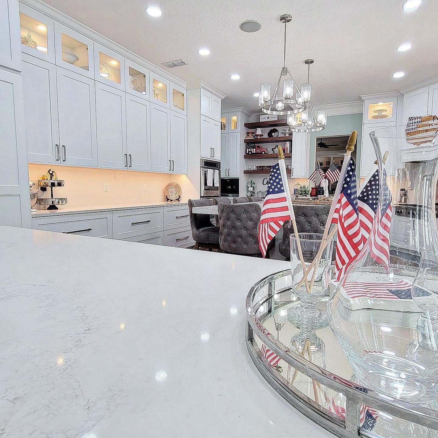 White kitchen with American flags on a reflective tray.