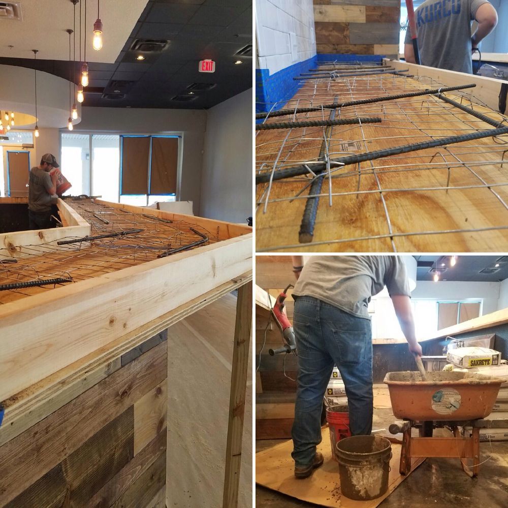 Construction of a bar. Workers add concrete, rebar, and wood. Inside a building.
