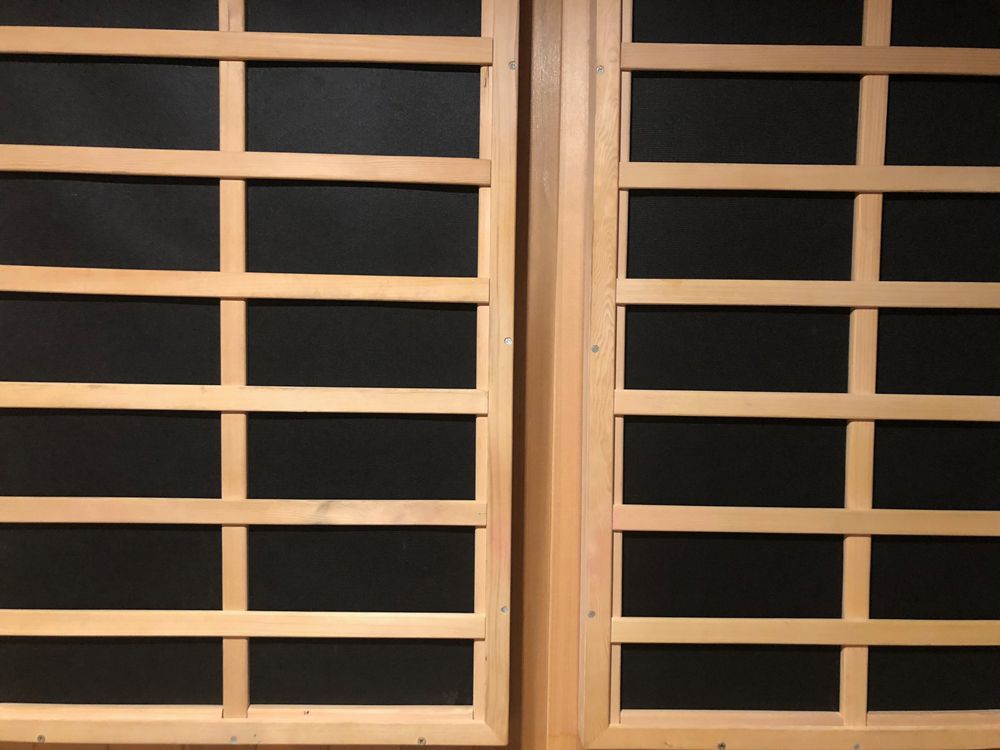 Two wooden-framed windows with a black background.