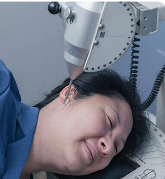 Doctor examining a patient’s back in a clinic, with hands on the upper and lower spine