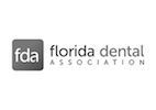 The logo for the florida dental association is black and white.