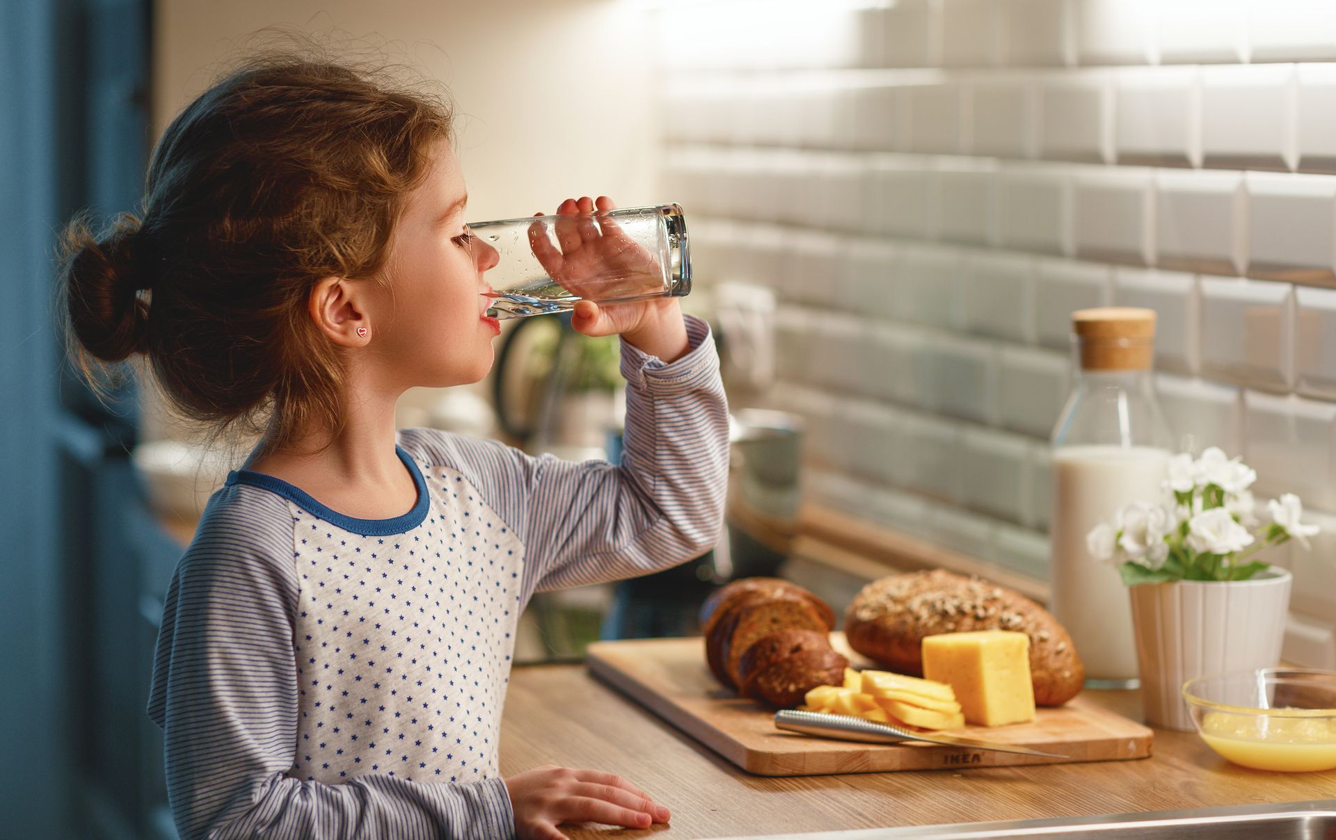 Young child drinking a glass of clean water at home in New Rochelle, New York.