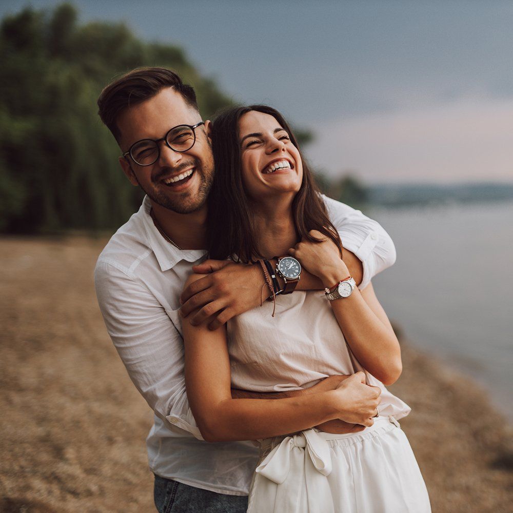 Young Couple At The Beach — Lake Worth, FL — Mercer Law Immigration Attorneys Young Couple At The Beach — Lake Worth, FL — Mercer Law Immigration Attorneys