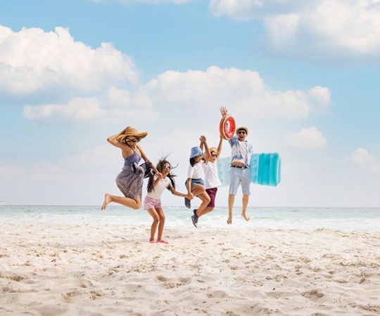 Family Doing A Jump Shot On The Beach — Lake Worth, FL — Mercer Law Immigration Attorneys Family Doing A Jump Shot On The Beach — Lake Worth, FL — Mercer Law Immigration Attorneys
