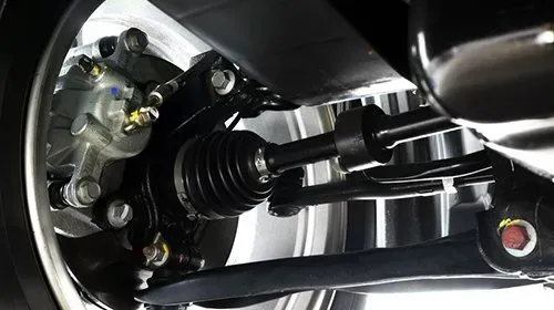Brake and suspension image showing underneath car at the wheel with caliper and  wheel drive shaft