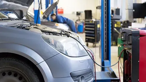 Heating and air conditioning repairs image sgowing a car connected to an electronic testing device