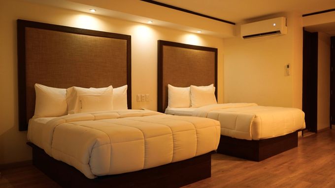A hotel room with a bed and a coffee maker.