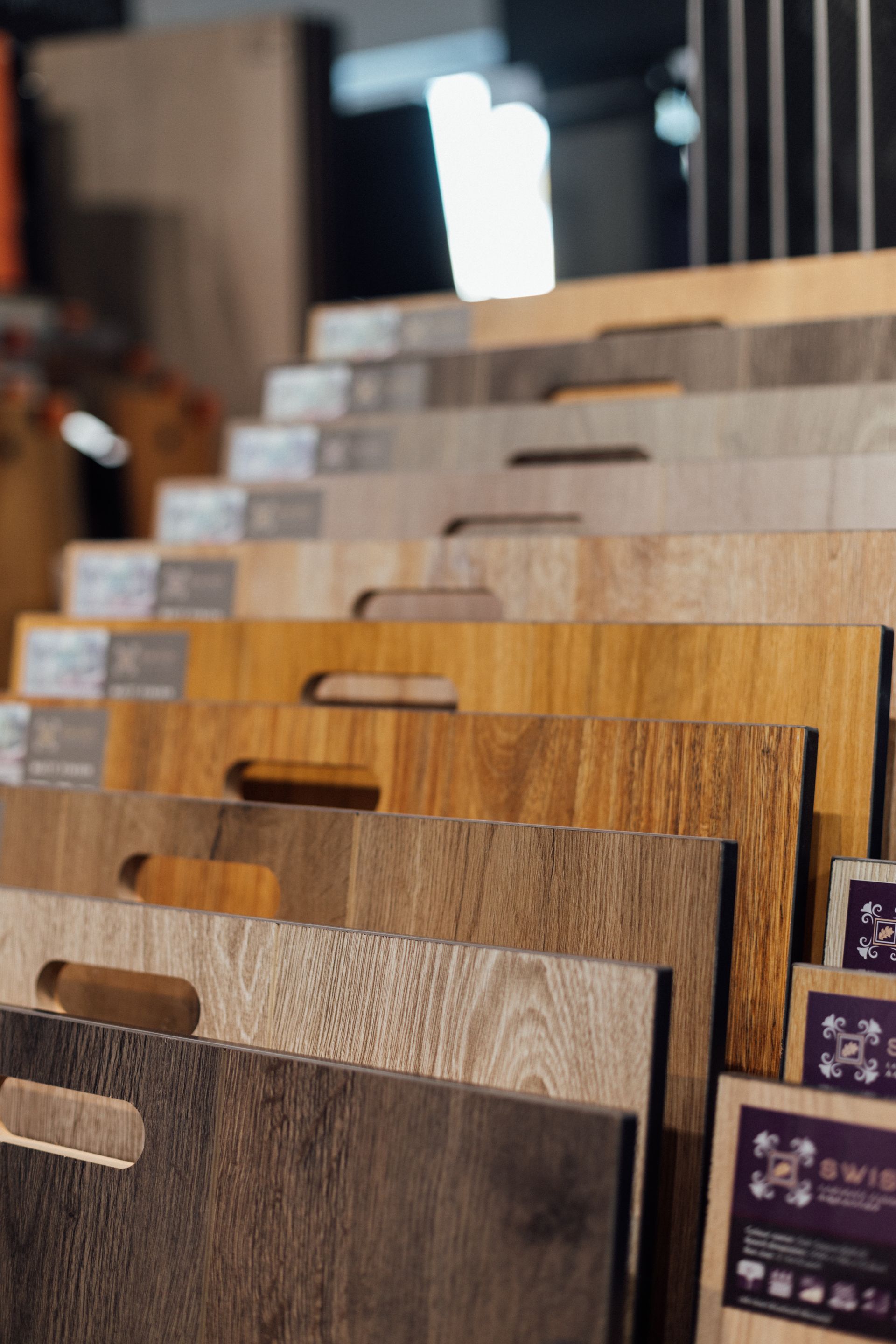 Display of assorted wood grain laminate samples in a showroom or store