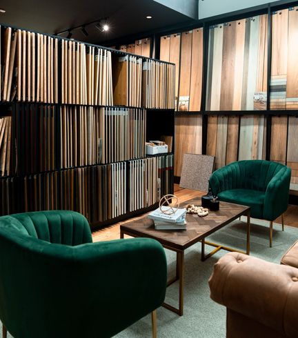 A living room with green chairs and a coffee table.