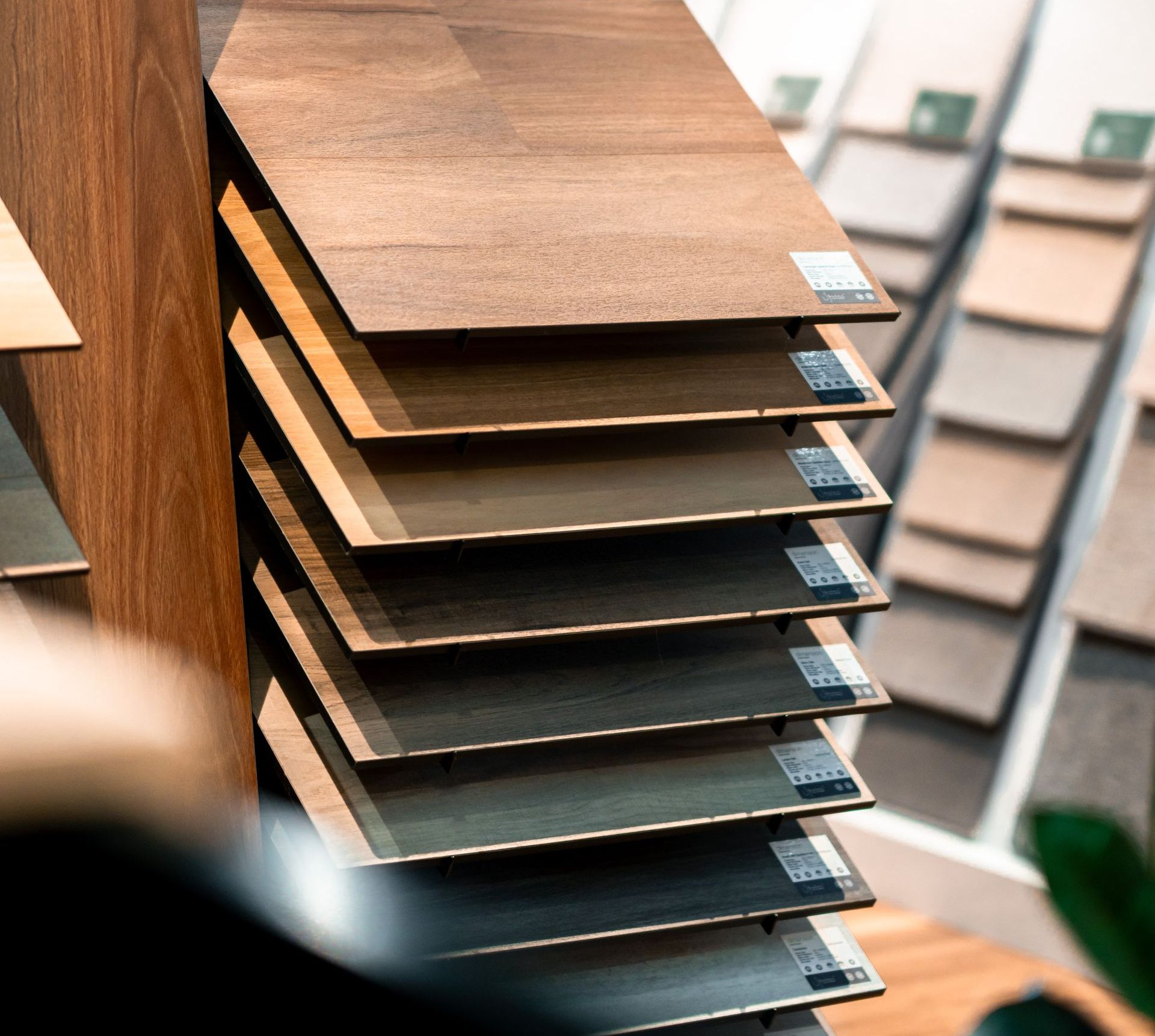 A showroom filled with lots of wooden floors and a plant.
