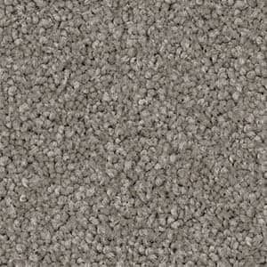A close up of a carpet with a lot of small stones on it.